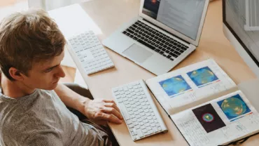 man multitasking, using computer, laptop, notebooks